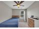 Bright bedroom featuring a statement ceiling fan, neutral walls, and a view of the window at 1936 Lakeshore Overlook Circle Nw Cir, Kennesaw, GA 30152