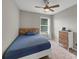 Cozy bedroom with a wood accent headboard, neutral walls, and a ceiling fan at 1936 Lakeshore Overlook Circle Nw Cir, Kennesaw, GA 30152