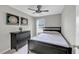 Comfortable bedroom with a bed, dark dresser, and natural lighting coming in through the window at 1936 Lakeshore Overlook Circle Nw Cir, Kennesaw, GA 30152