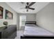 Bedroom with fan, dresser, and window featuring natural light at 1936 Lakeshore Overlook Circle Nw Cir, Kennesaw, GA 30152
