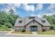 Charming stone clubhouse exterior boasts an appealing facade, complemented by lush green landscaping, and blue sky at 1936 Lakeshore Overlook Circle Nw Cir, Kennesaw, GA 30152