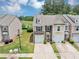 Charming townhome exterior boasts a well-manicured lawn and easy access to a scenic lake at 1936 Lakeshore Overlook Circle Nw Cir, Kennesaw, GA 30152