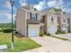 Attractive townhome featuring a one-car garage, well-maintained landscaping, and inviting curb appeal at 1936 Lakeshore Overlook Circle Nw Cir, Kennesaw, GA 30152