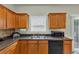 Kitchen features modern appliances, sleek counters, and natural wood cabinetry at 1936 Lakeshore Overlook Circle Nw Cir, Kennesaw, GA 30152