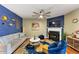 Comfortable living room with fireplace, hardwood floors, stylish furniture and decor, and a ceiling fan at 1936 Lakeshore Overlook Circle Nw Cir, Kennesaw, GA 30152