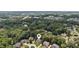 Aerial view of a luxurious home in a neighborhood surrounded by lush, mature trees at 2145 Sugarstone Ct, Lawrenceville, GA 30043