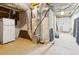Unfinished basement with exposed ducts, concrete walls and floor. Refrigerator included at 2145 Sugarstone Ct, Lawrenceville, GA 30043