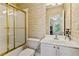 Bathroom with glass-door shower, toilet, and single vanity at 2145 Sugarstone Ct, Lawrenceville, GA 30043