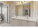 Bathroom with double vanity, framed mirror, and access to water closet at 2145 Sugarstone Ct, Lawrenceville, GA 30043