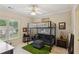 Bedroom with ceiling fan, large window, and lofted bed at 2145 Sugarstone Ct, Lawrenceville, GA 30043