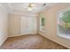 Bedroom with double closets, ceiling fan, and large windows at 2145 Sugarstone Ct, Lawrenceville, GA 30043