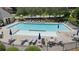 Large community pool with ample seating and umbrellas, perfect for summer relaxation at 2145 Sugarstone Ct, Lawrenceville, GA 30043