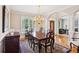 Formal dining room with chandelier, hardwood floors, and natural light at 2145 Sugarstone Ct, Lawrenceville, GA 30043