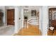 Spacious foyer featuring hardwood floors, staircase, and decorative columns at 2145 Sugarstone Ct, Lawrenceville, GA 30043