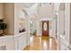 Elegant foyer with gleaming hardwood floors and arched doorways at 2145 Sugarstone Ct, Lawrenceville, GA 30043