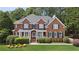 Charming two-story brick home with a well-manicured lawn and mature landscaping at 2145 Sugarstone Ct, Lawrenceville, GA 30043
