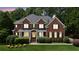 Charming two-story brick home with a well-manicured lawn and mature landscaping at 2145 Sugarstone Ct, Lawrenceville, GA 30043