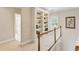 Upstairs hallway features a built-in bookcase at 2145 Sugarstone Ct, Lawrenceville, GA 30043
