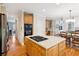 Bright kitchen island with breakfast bar, stainless appliances, and hardwood floors at 2145 Sugarstone Ct, Lawrenceville, GA 30043