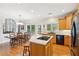 Eat-in kitchen with island, gas cooktop, stainless appliances, and large windows at 2145 Sugarstone Ct, Lawrenceville, GA 30043