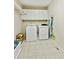 Functional laundry room with washer, dryer, and storage cabinets at 2145 Sugarstone Ct, Lawrenceville, GA 30043
