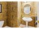 Elegant powder room featuring unique wallpaper and a pedestal sink at 2145 Sugarstone Ct, Lawrenceville, GA 30043
