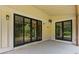Covered back porch area with sliding glass doors and an outdoor fan for comfortable relaxation at 407 Westside Dr, Roswell, GA 30075