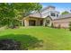 Expansive backyard with green lawn and a charming single-Gathering home with a covered porch at 407 Westside Dr, Roswell, GA 30075