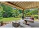 Relaxing covered patio with comfortable seating and a view of the expansive, green backyard at 407 Westside Dr, Roswell, GA 30075