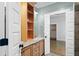 A bathroom vanity features a marble countertop and built-in shelving for storage with views to bedroom and closet at 407 Westside Dr, Roswell, GA 30075