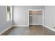 A gray painted bedroom features wood shelving in closet and a window, adding natural light to the room at 407 Westside Dr, Roswell, GA 30075