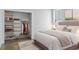 Stylishly furnished bedroom features a well-organized closet with wood shelving, enhancing comfort and convenience at 407 Westside Dr, Roswell, GA 30075