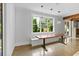 Dining Area with wooden table, bench seating, pendant lighting, and view of the backyard at 407 Westside Dr, Roswell, GA 30075