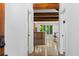 Inviting entryway with exposed beam ceilings, polished floors, and open concept to kitchen and dining at 407 Westside Dr, Roswell, GA 30075