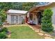 Home exterior with a porch swing, stone pathway, well-manicured lawn and charming small shed at 407 Westside Dr, Roswell, GA 30075