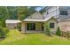 Home exterior with a covered patio, a manicured lawn, and lush greenery at 407 Westside Dr, Roswell, GA 30075