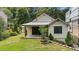 Beautifully landscaped backyard with a covered patio and a well-maintained lawn at 407 Westside Dr, Roswell, GA 30075