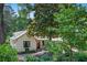 Charming home with light siding, well-kept landscaping, a metal roof, and lovely curb appeal at 407 Westside Dr, Roswell, GA 30075