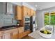 Kitchen features stainless steel appliances, granite countertops, light cabinets, and tile backsplash at 407 Westside Dr, Roswell, GA 30075