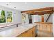 Bright kitchen features wood beams, granite counters, stainless appliances, and a dining area with large windows at 407 Westside Dr, Roswell, GA 30075