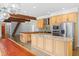Open concept kitchen with stainless steel appliances, large island, wooden beams, and concrete floors at 407 Westside Dr, Roswell, GA 30075