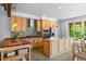 Bright kitchen features wooden cabinets, stainless appliances, island with seating, and access to the outdoor patio at 407 Westside Dr, Roswell, GA 30075