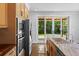 Kitchen with stainless appliances, light cabinets, and sliding doors to the outdoor space and backyard at 407 Westside Dr, Roswell, GA 30075