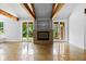 Bright living room showcasing a fireplace, exposed beams, and large sliding glass doors at 407 Westside Dr, Roswell, GA 30075