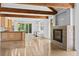 An open-concept living room with fireplace, exposed beams, and natural light at 407 Westside Dr, Roswell, GA 30075