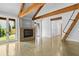 Cozy living room with fireplace, exposed beams, and access to outdoor patio area at 407 Westside Dr, Roswell, GA 30075