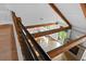 Top-down view of the living space with exposed beams and black railings overlooking the fireplace and backyard at 407 Westside Dr, Roswell, GA 30075