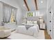 Serene bedroom with soft lighting, beamed ceilings, and neutral decor for a relaxing retreat at 407 Westside Dr, Roswell, GA 30075