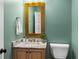 A stylish powder room featuring a marble countertop and decorative gold-framed mirror at 407 Westside Dr, Roswell, GA 30075