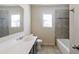 Well-lit bathroom with a combination tub/shower with gray tiling and mosaic accents, plus a sleek vanity at 7790 Stratford Ln, Atlanta, GA 30350